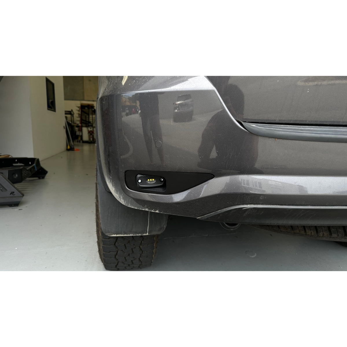Fortuner Rear Work Lights Bracket installed in rear bumper with ROK9 light mounted