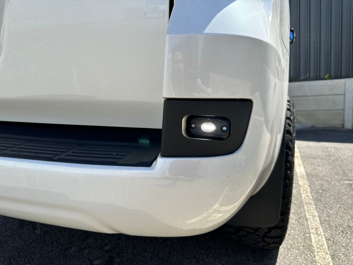 LC200 Rear Work Lights Bracket installed with Lightforce ROK9 light illuminated in bumper