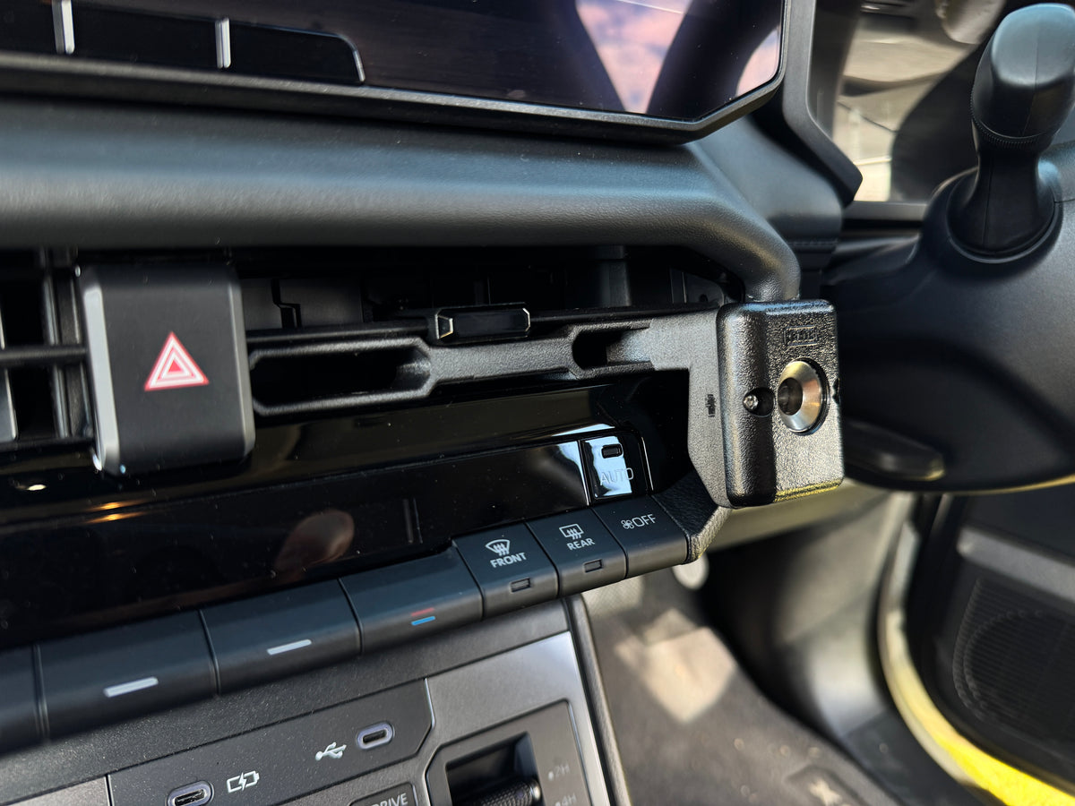 Close-up of the 3D printed bracket clipped into the Hilux N90 centre vent with mic clip screw mount
