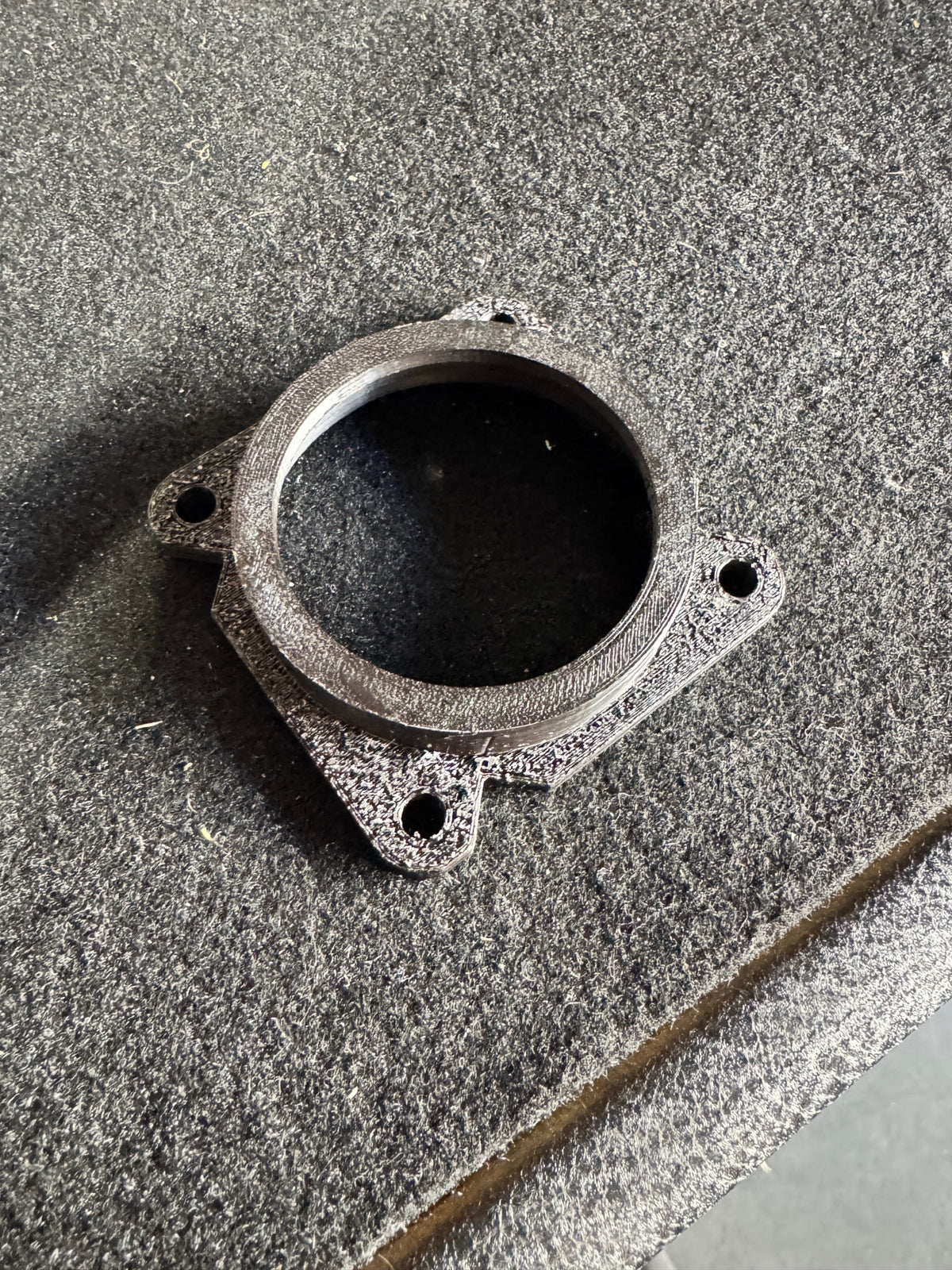 Adapter on carpet — showing profile and screw holes