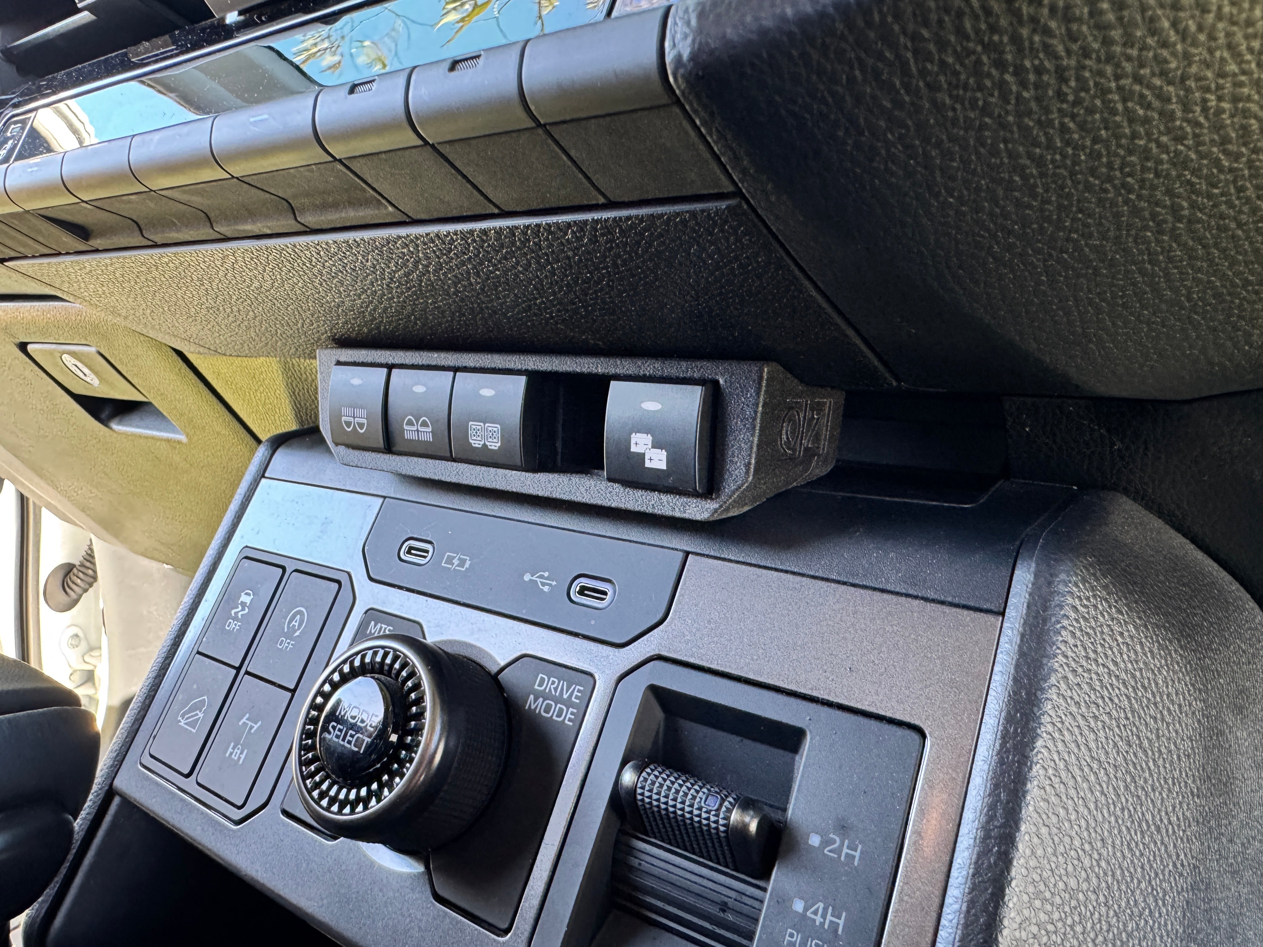 Installed in the N90 Hilux — side angle showing OZ logo and factory fit